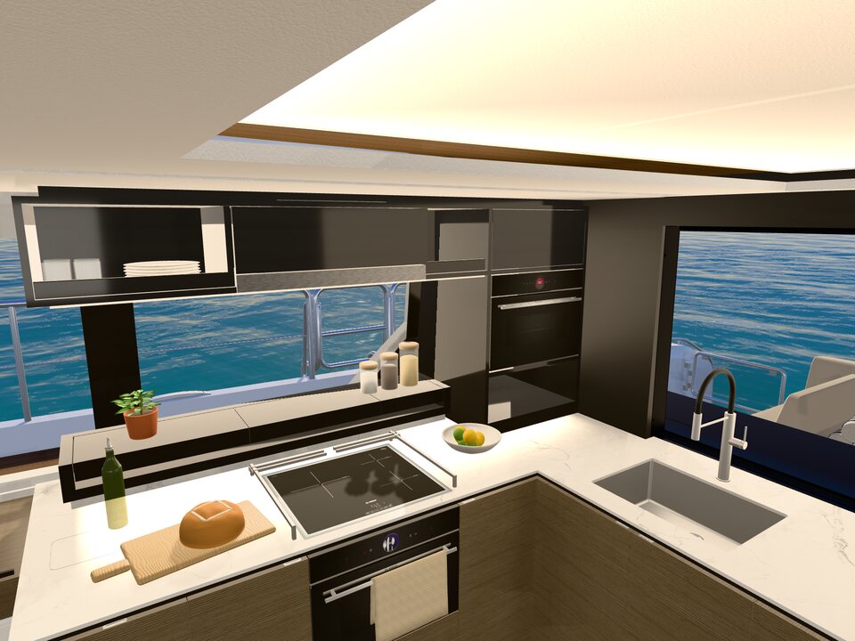 The galley: a stone worktop with fresh bread, lemons and olive oil, the induction hob and the sink, the sea in the window.