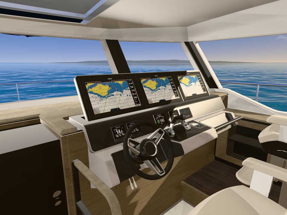 The main helm: the wheel and three chart screens, the sea through the wide windscreen.