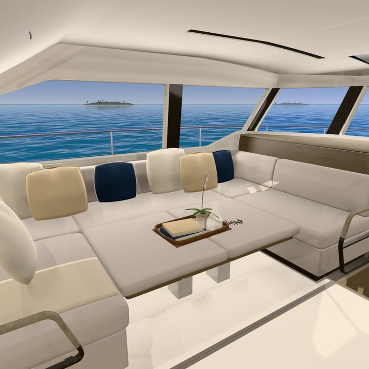 The saloon sofa with navy and sand cushions, a tray with an orchid and books, islands in the windows.